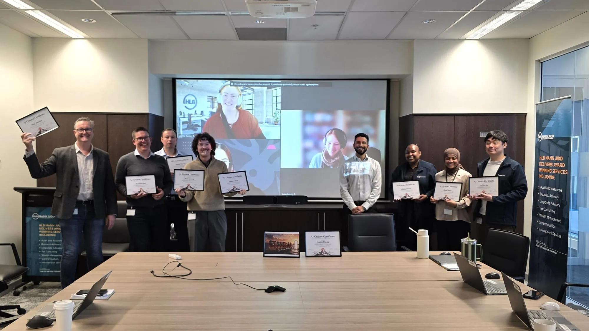 The HLB Mann Judd Wealth Management team holding their AI Creator certificates at the Sprint showcase, with Jenish Pandya